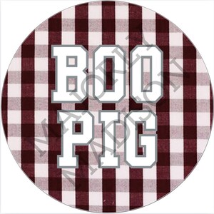 May include: A white circle with a red and white checkered pattern. The words "BOO PIG" are written in white with a gray outline on the circle.