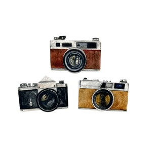 May include: Watercolor illustration of three vintage cameras. The cameras are in shades of brown, black, and tan with silver accents. Each camera has a prominent lens and various dials and buttons, suggesting a classic design.