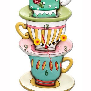 May include: A whimsical clock shaped like a stack of teacups and saucers. The clock face is on the second cup, with yellow and black stripes and a red hand. The top cup has a green and white polka dot pattern with a pink rose. The clock has a pendulum shaped like a teapot.