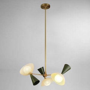 Może przedstawiać: Nowoczesny mosiężny żyrandol z pięcioma światłami. Oprawy oświetleniowe mają oliwkowozielone i kremowe perforowane klosze. Centralny trzon i mocowanie sufitowe są w kolorze mosiądzu. Projekt jest nowoczesny i pasuje do różnych stylów wnętrz.