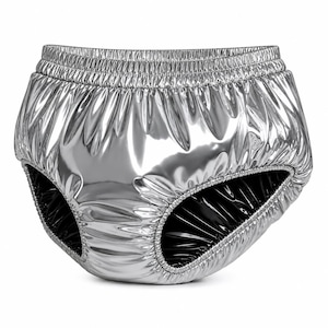 May include: High-waisted briefs in a metallic silver finish with a reflective, glossy surface. The garment features an elasticated waistband and leg openings, with a black interior lining visible at the leg holes and a gathered, pleated texture.