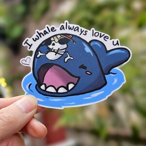 May include: A blue whale with a skull and crossbones on its back, with the text "I whale always love u" above it. The whale is smiling and has a heart next to it.