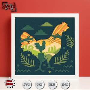 Könnte beinhalten: Ein gerahmtes, geschichtetes Papierkunstwerk mit einer Hahn-Silhouette und einer Landschaftsszene im Inneren. Das Kunstwerk verwendet Grün-, Orange- und Blautöne. Der Rahmen ist weiß und der Hintergrund rot.