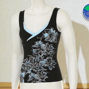 May include: Black tank top with a light blue trim and floral design. The tank top features a scoop neckline and a floral pattern in shades of blue and white. The tank top is displayed on a mannequin.