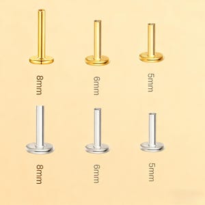 May include: A collection of gold and silver-colored labret studs. The studs are available in 5mm, 6mm, and 8mm lengths. The image shows the studs from a top-down perspective, with the measurements clearly labeled in millimeters.