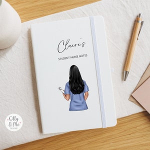 May include: A white notebook with a blue and white illustration of a nurse holding a clipboard. The notebook has the text "Claire's Student Nurse Notes" printed on the front.