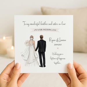 May include: A square white wedding greeting card featuring an illustration of a bride in a white gown and a groom in a black suit. The text reads: To my wonderful brother and sister-in-law ON YOUR WEDDING DAY, Ryan & Lauren, 28.09.2025, Wishing you a lifetime of happiness together.