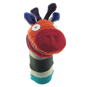 Peut inclure: Une marionnette de main colorée en tissu tricoté, en forme de girafe avec un nez rouge, des rayures orange et brunes et des oreilles bleues.