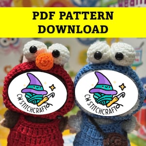 May include: Two crocheted dolls, one red and one blue, with large white eyes and orange and blue accents. Each doll has a circular logo with a witch hat and the text "CW STITCHCRAFT". The top of the image reads "PDF PATTERN DOWNLOAD".
