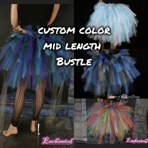 May include: A custom color mid-length tulle bustle. The bustle is made of multiple layers of tulle in a variety of colors, including blue, green, purple, and gold. The bustle is shown in three different color combinations: blue and white, blue and gold, and rainbow.