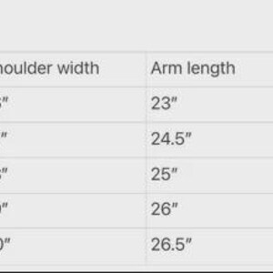 May include: A jacket sizing chart with measurements in inches. The chart includes sizes from Small to 2XL, listing shoulder width, arm length, and waist measurements for each size. The text "Jacket sizing" is at the top.