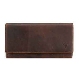 May include: A brown leather wallet with a fold-over flap. The wallet has a textured surface and visible stitching around the edges. A small embossed bull logo is visible on the lower right corner.