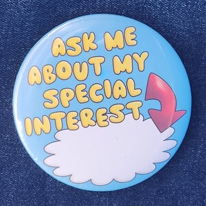 May include: A blue button with a white cloud and a red arrow pointing to the cloud. The text on the button reads "Ask me about my special interest."