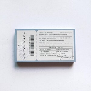 May include: A light blue and white Witch Post customs declaration form. The form includes text, a barcode, and a signature. The form states the weight is 8.000g and the contents are Devil's soul.