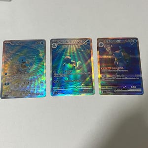 May include: Three holographic Pokémon cards featuring Squirtle, Wartortle, and Blastoise. The cards are from the Japanese Pokémon Trading Card Game.