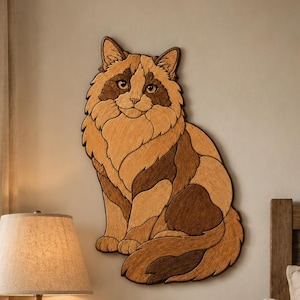 May include: A wall-mounted wooden cat sculpture featuring a multi-tonal brown and tan layered design. The cat is depicted in a seated position with a fluffy tail curled around its body, showcasing intricate wood grain patterns and dark outlines.