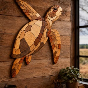 May include: A wall-mounted sea turtle sculpture crafted from various shades of natural wood. The piece features a mosaic-like pattern of interlocking wooden segments in light, medium, and dark brown tones, forming the shell, head, and flippers.