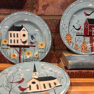 May include: A set of three ceramic mugs with a speckled, matte finish. The mugs are in shades of cream, light gray, and dark gray. Each mug has a simple, minimalist design, perfect for coffee or tea.