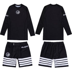 May include: Black rash guard and shorts set. The long-sleeve shirt and shorts are black with white accents. The shirt has a circular logo on the chest and the word "Ataque" on the sleeve. The shorts have three white stripes.