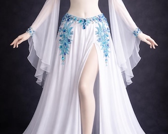 May include: A white belly dance costume with blue accents. The ensemble includes a jeweled bra, arm cuffs, and ankle bracelet. The skirt has a high slit and is adorned with blue embellishments. Long, sheer sleeves complete the look.