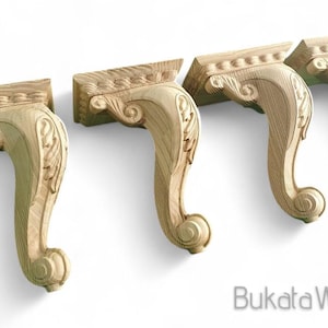 May include: Four unfinished wooden furniture legs with intricate carvings. The legs are shaped like a scroll and have a rounded bottom.