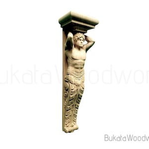 May include: A carved wooden corbel featuring a muscular male figure supporting a rectangular block. The figure is detailed with carved hair, a defined torso, and decorative lower garments. The corbel is made of light-colored wood.