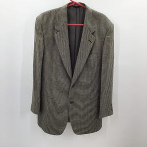 May include: A brown and black checkered blazer with a single button closure.
