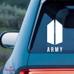 May include: A white vinyl decal applied to a dark blue car window. The design features two vertical, parallel trapezoidal shapes forming a stylized door icon, with the word ARMY printed in a clean, sans-serif white font directly underneath.