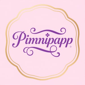 May include: A pink background with a gold-colored, scalloped border. The text "Pimnipapp" is written in a purple, cursive font within the border. The design has a vintage, elegant feel.