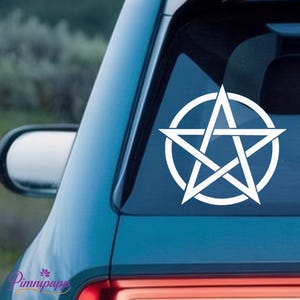 May include: A white vinyl decal featuring a pentacle design, consisting of a five-pointed star enclosed within a circle. The decal is applied to the rear window of a vehicle, displaying clean, sharp lines and a solid white color throughout the graphic.