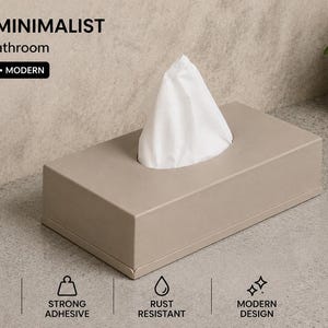 Puede incluir: Un dispensador de pañuelos rectangular de color beige con un pañuelo blanco sobresaliendo por la parte superior. El texto en la imagen incluye MODERN & MINIMALIST, NO DRILL, NO DAMAGE, 5 MIN INSTALL, DAMAGE FREE, STRONG ADHESIVE, RUST RESISTANT y MODERN DESIGN.