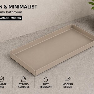 Può includere: Un vassoio rettangolare beige con bordi rialzati. Il testo sull'immagine include: MODERN & MINIMALIST, Perfect for any bathroom, NO DRILL NO DAMAGE MODERN, NO DRILL, 5 MIN INSTALL, DAMAGE FREE, STRONG ADHESIVE, RUST RESISTANT e MODERN DESIGN.