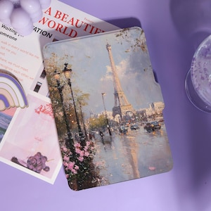 May include: A tablet case with an impressionistic painting of the Eiffel Tower in Paris. The artwork shows a rainy street scene with streetlights and pink flowers. The text "A BEAUTIFUL WORLD" is visible.