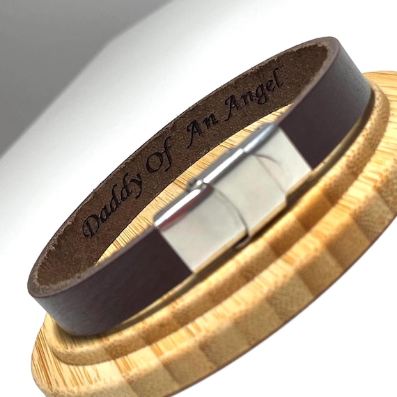 A leather bracelet with a hidden Morse code message only the wearer knows — a genuinely clever, secret-language way to carry a memorial or love note on your wrist.