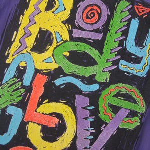 May include: Purple t-shirt with a colorful, abstract design. The design features the word "BOY LOVE" in various bright colors, including yellow, green, red, and blue, against a black background.