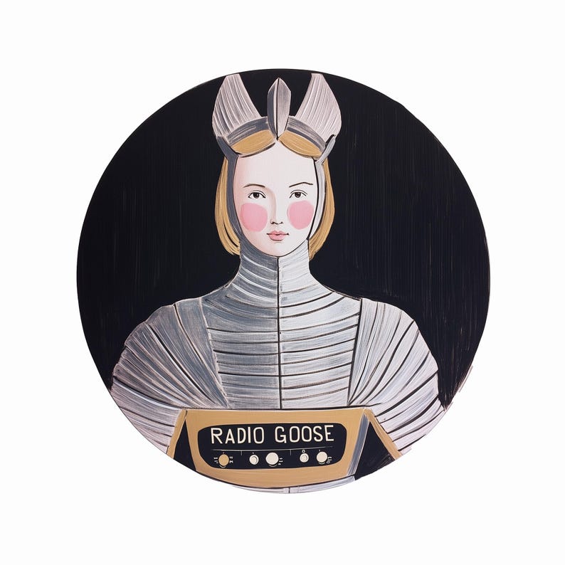 May include: A round painting featuring a person in a silver and white outfit with a crown, holding a gold radio with the text "RADIO GOOSE". The background is black, and the person has blonde hair and pink cheeks.