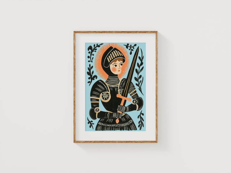 May include: Framed art print featuring a stylized illustration of a figure in black armor holding a sword. The figure has a halo and is set against a light blue background. The artwork is framed in a natural wood tone.