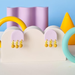 80's memphis style handmade polymer clay arch earrings. dangly geometrical statement studs with three contrasting dangles