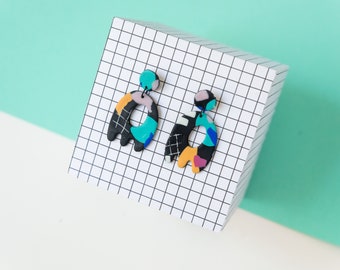 black & multicolored 80's memphis style handmade polymer clay earrings. geometrical pink, mint, yellow and white grid statement dangles