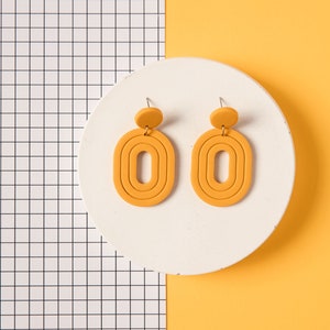 Kleurrijke geometrische handgemaakte polymeer klei oorbellen in jaren 80 stijl. Minimalistische Art deco hangers in verschillende kleuren Yellow