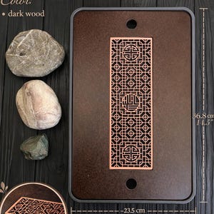 May include: Dark wood tea table with a decorative metal drain grate. The table measures 14.5 x 9.2 inches. The table is made of wood and plastic. The table has a dark wood color.