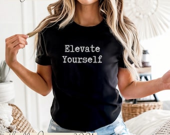 May include: Black t-shirt with the text "Elevate Yourself" in white. The shirt is a Bella Canvas 3001 model. The word "Black" is written in cursive at the top left of the image.