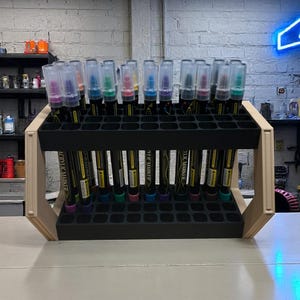 "Marker stand with 44 slots, positioned at an angle for easy access"