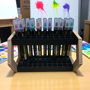 "Creative tool display stand with two rows of paint pens"