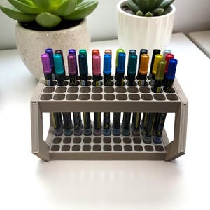 "Front view of 3D printed marker holder with 44 pens neatly arranged"