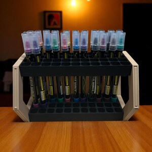 "Art marker rack holding colorful paint pens on wooden table"