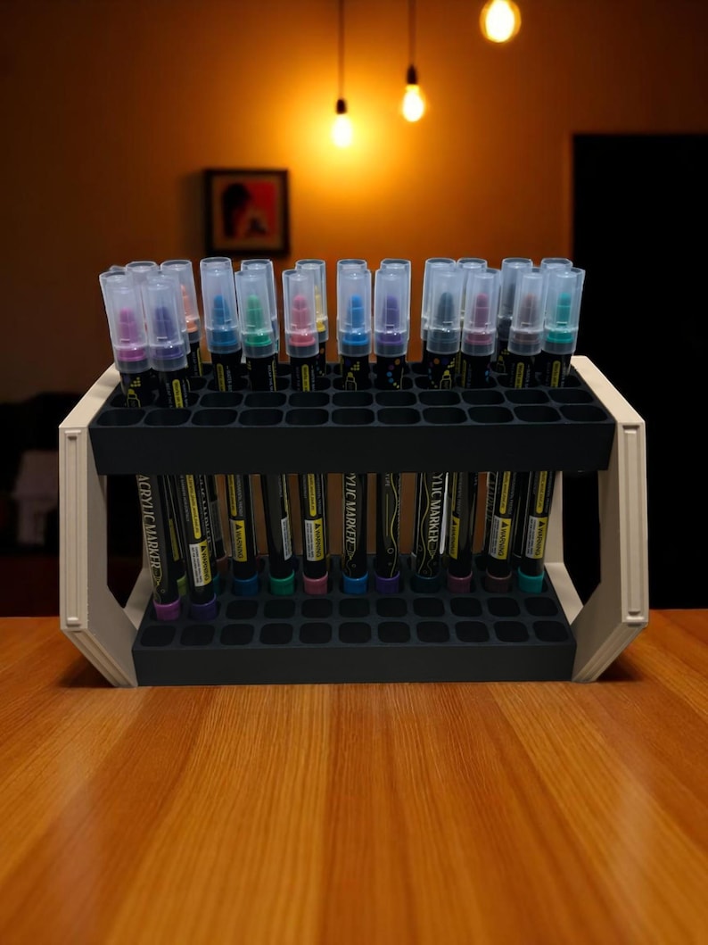 "Art marker rack holding colorful paint pens on wooden table"
