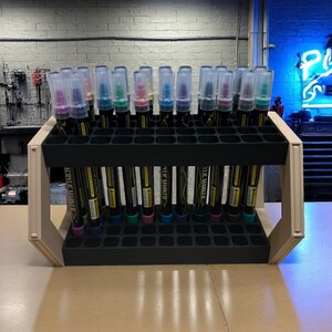 "Creative tool display stand with two rows of paint pens"