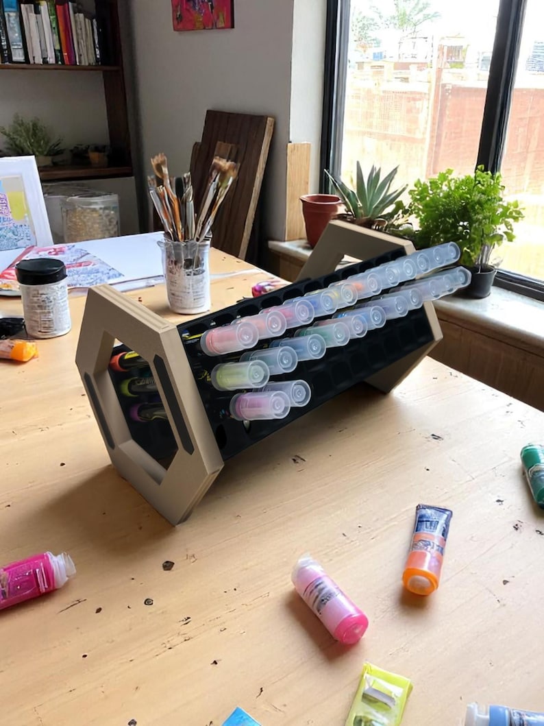 "Acrylic marker organizer with dual-angle stand on workshop desk"