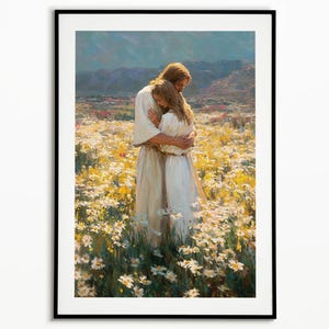 May include: Framed art print depicting two figures embracing in a field of white and yellow flowers. The figures are dressed in white robes, with one figure having long brown hair. The background features rolling hills and a blue sky.